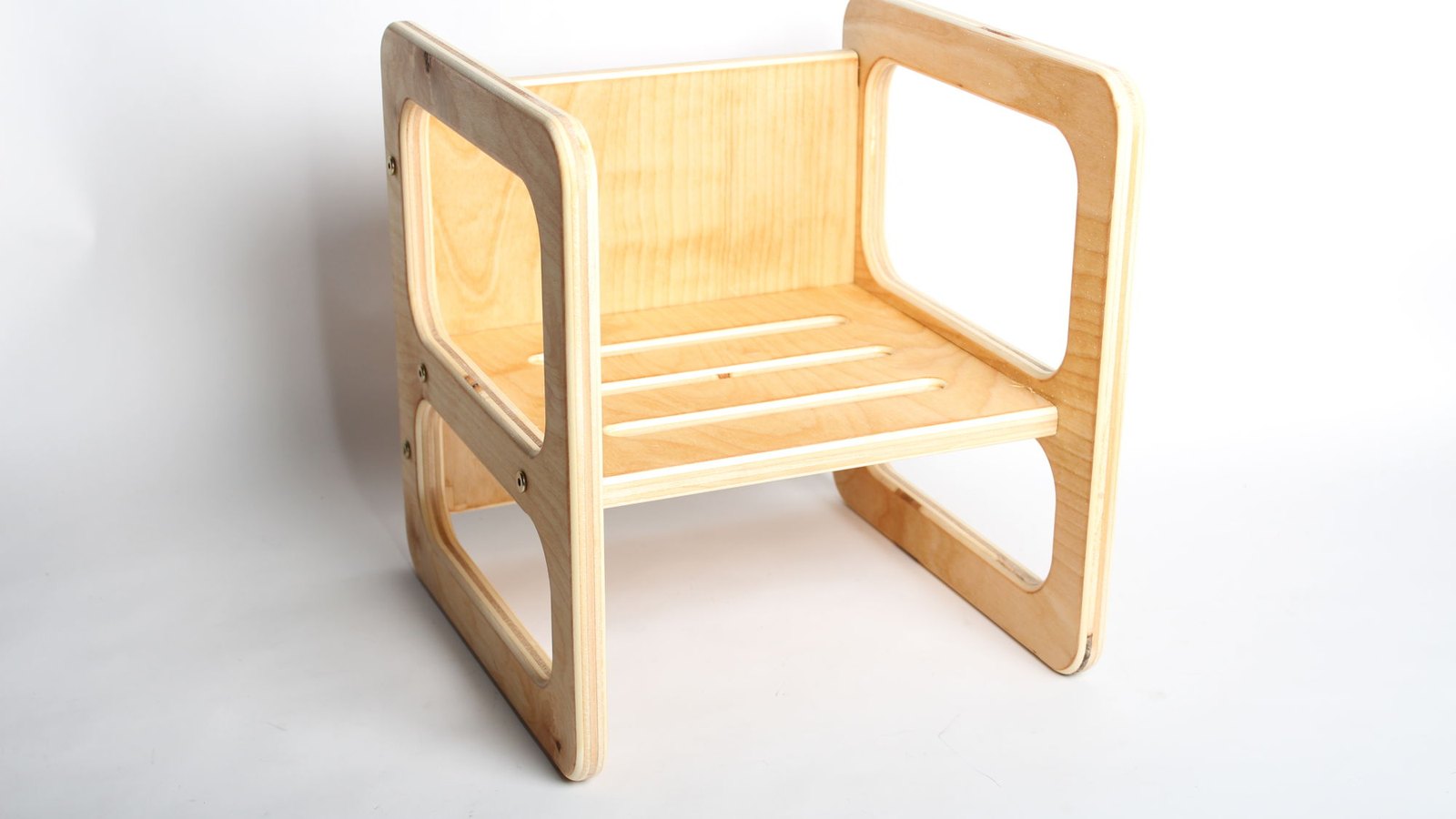 A birch plywood Montessori cube chair, reversible to give two seat heights